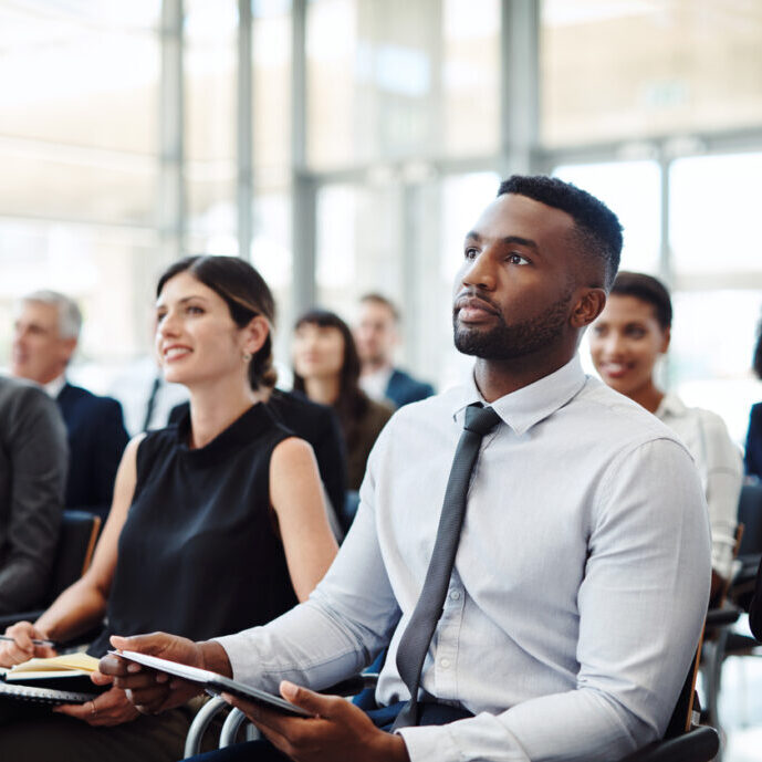 Shot of a group of businesspeople attending a conference
